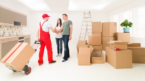 Professional movers handling office equipment